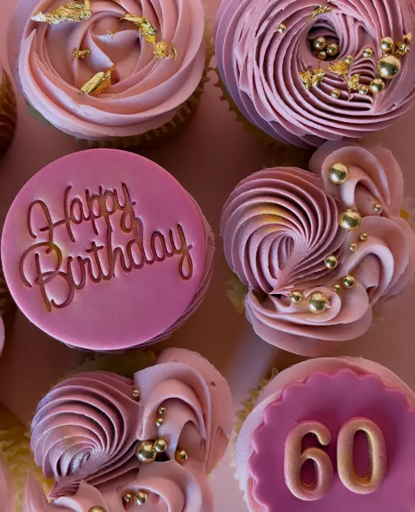 Pink swirled birthday cupcakes