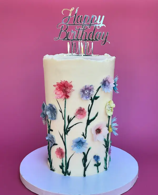 Tall white cake with hand-piped wildflowers