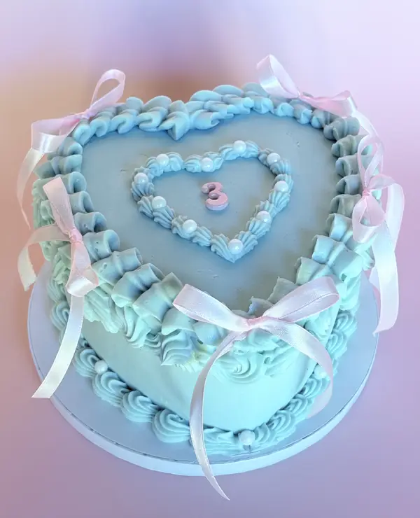 Vintage heart cake with blue piping and pink bows